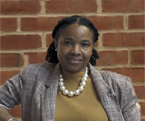 Dawn Roberts Ed.D. headshot on brick background