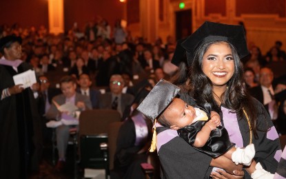 Alisha Karley, DDS ’24, holding her baby, was among the 128 dental students and 12 dental hygiene students who marched May 17 during the Honors Convocation at the Hippodrome Theatre. (Photos by Matthew D’Agostino / UMB)
