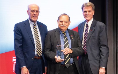 Barry L. Cohan is joined by (from left) UMB President Bruce Jarrell and UMSOD Dean Mark Reynolds after receiving the Catalyst for Excellence award.